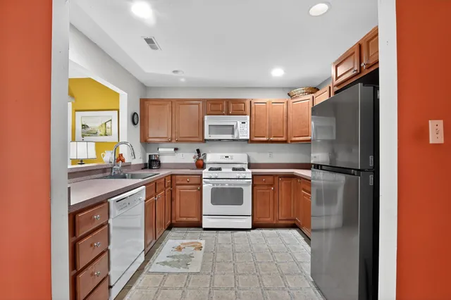 a kitchen with stainless steel appliances granite countertop a refrigerator sink and cabinets