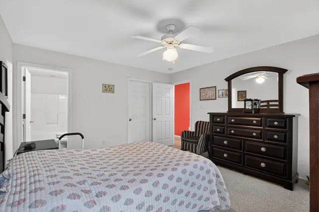 a bedroom with a bed and a dresser