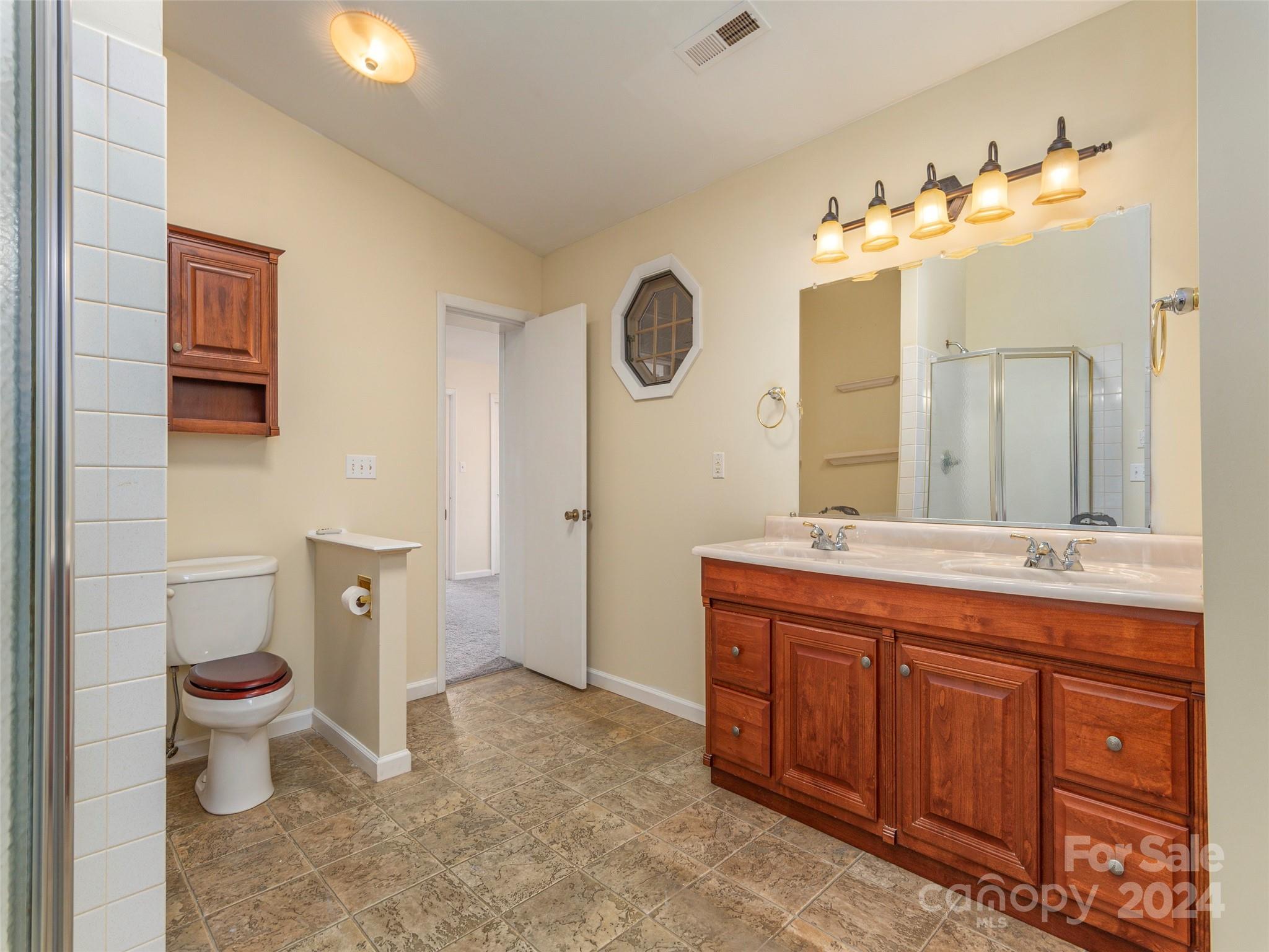 40 Wagon Road Asheville, NC 28805 - Photo 16 of 29 a spacious bathroom with a granite countertop sink toilet and mirror