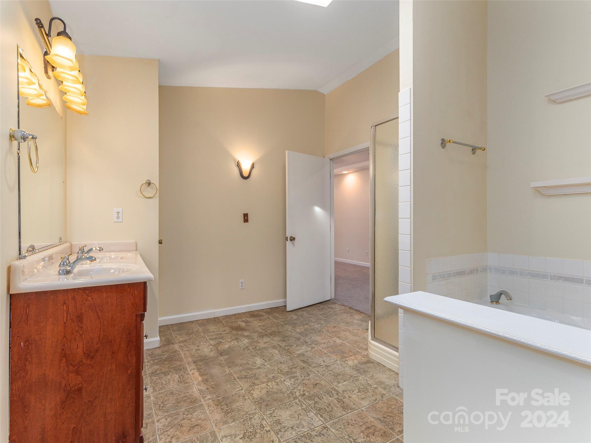 40 Wagon Road Asheville, NC 28805 - Photo 18 of 29 a bathroom with a tub sink and mirror