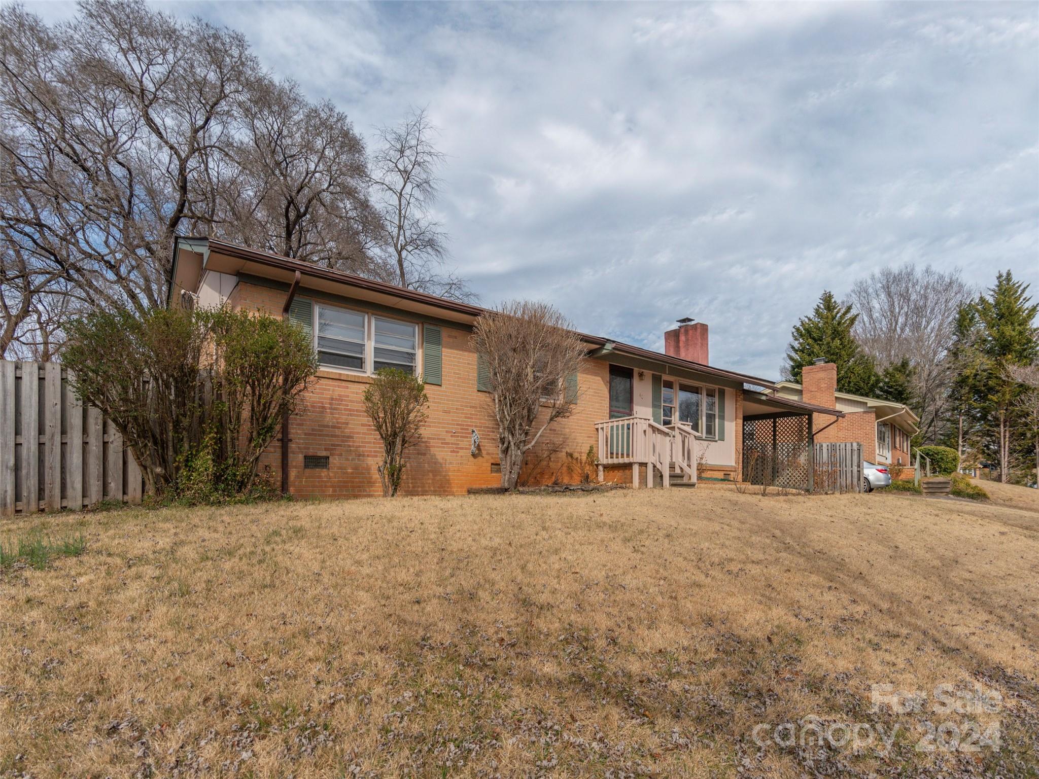 40 Wagon Road Asheville, NC 28805 - Photo 27 of 29 a big house with large tree and wooden fence