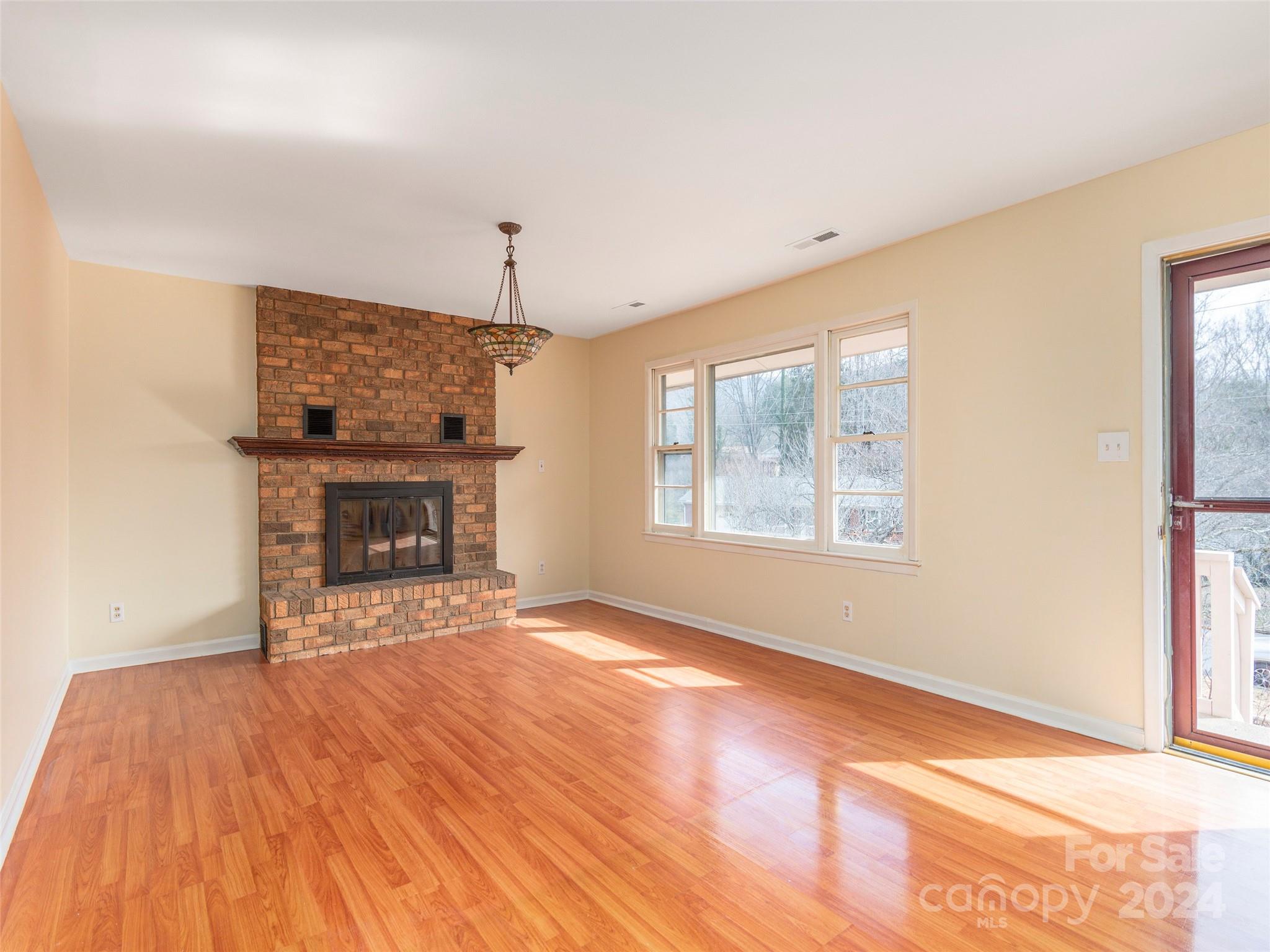 40 Wagon Road Asheville, NC 28805 - Photo 4 of 29 a view of empty room with fireplace and wooden floor