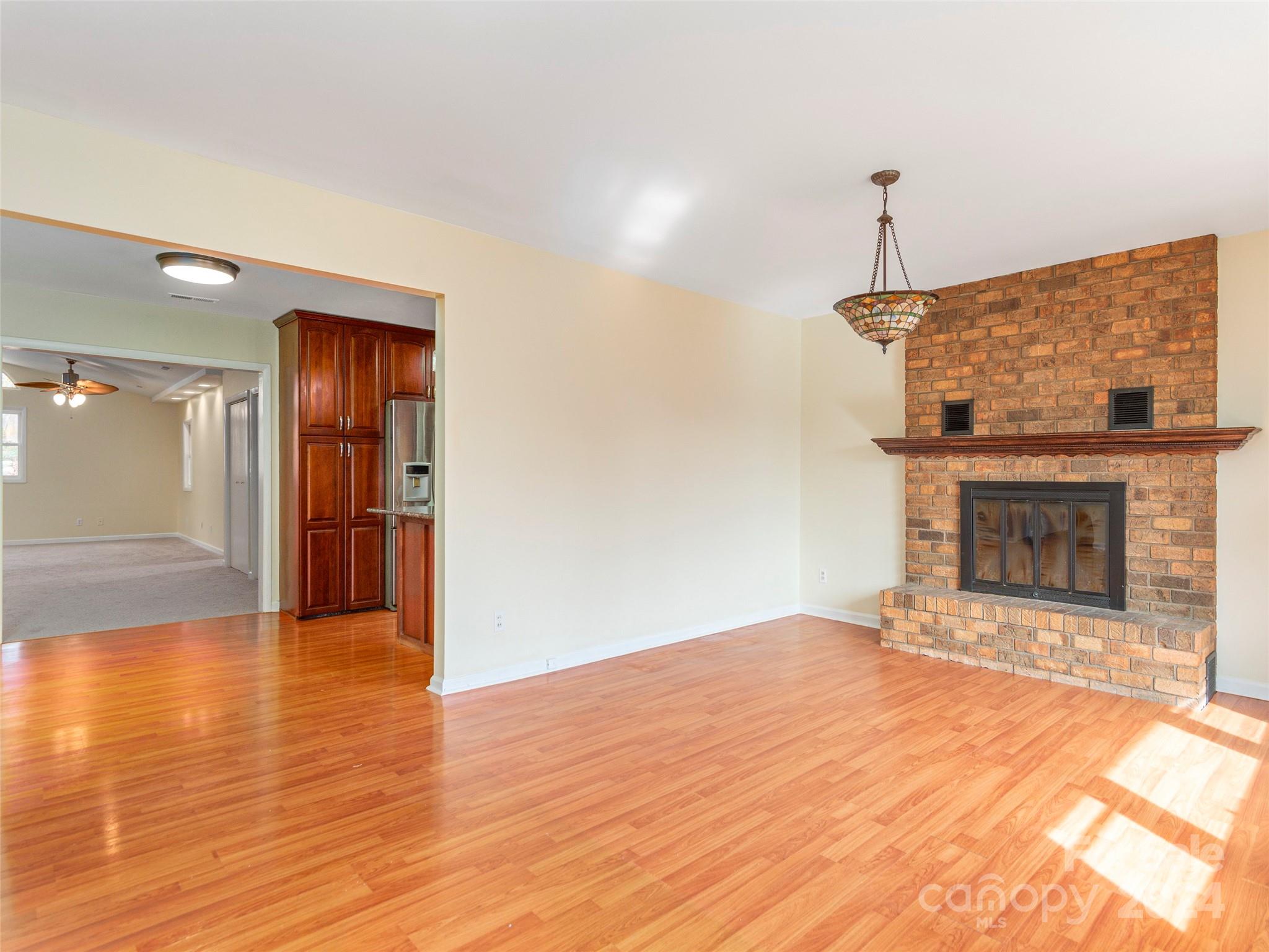 40 Wagon Road Asheville, NC 28805 - Photo 5 of 29 a view of an empty room with wooden floor fire place and a fireplace
