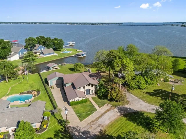 an aerial view of a house with a lake view
