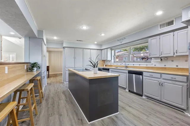 a kitchen with counter top space sink and center island
