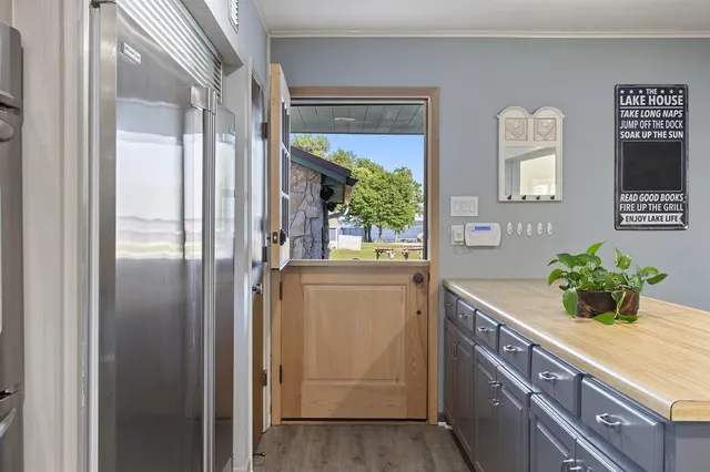 a kitchen with stainless steel appliances granite countertop a refrigerator and a more cabinets