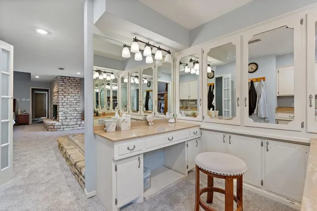 a bathroom with a sink a tub and a mirror