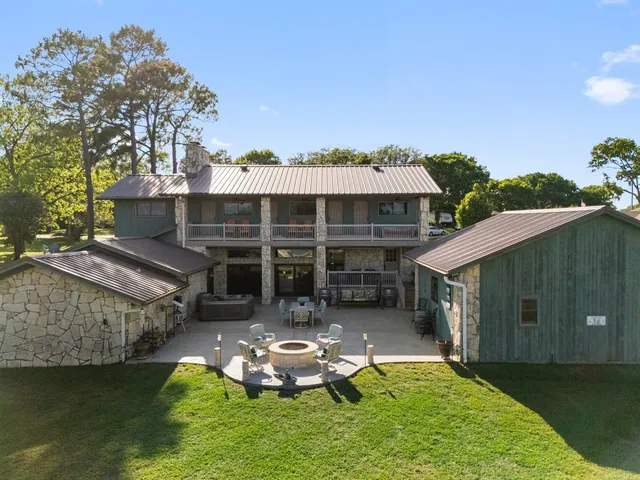 a backyard of a house with yard table and chairs