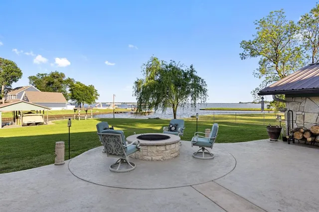 a view of a patio with table and chairs and potted plants
