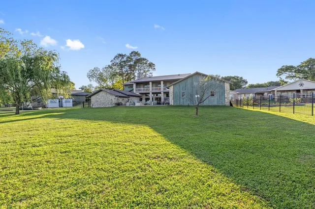 a view of a house with a yard and sitting area