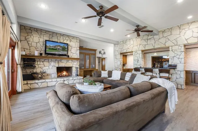 a living room with furniture a fireplace and a flat screen tv