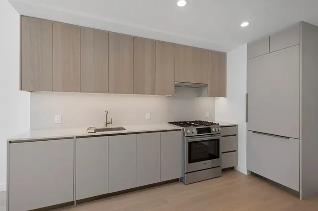 a kitchen with granite countertop a stove and a sink