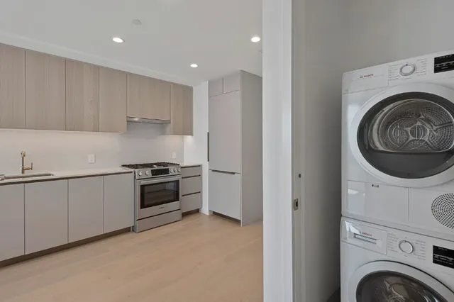 a view of a kitchen with a sink and dishwasher