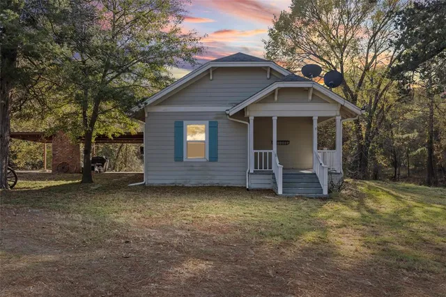 a living room with furniture a flat screen tv and a large window