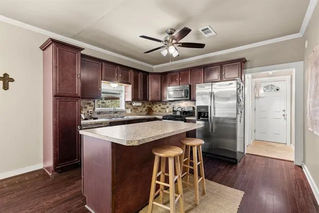 a bathroom with a double vanity sink mirror and toilet