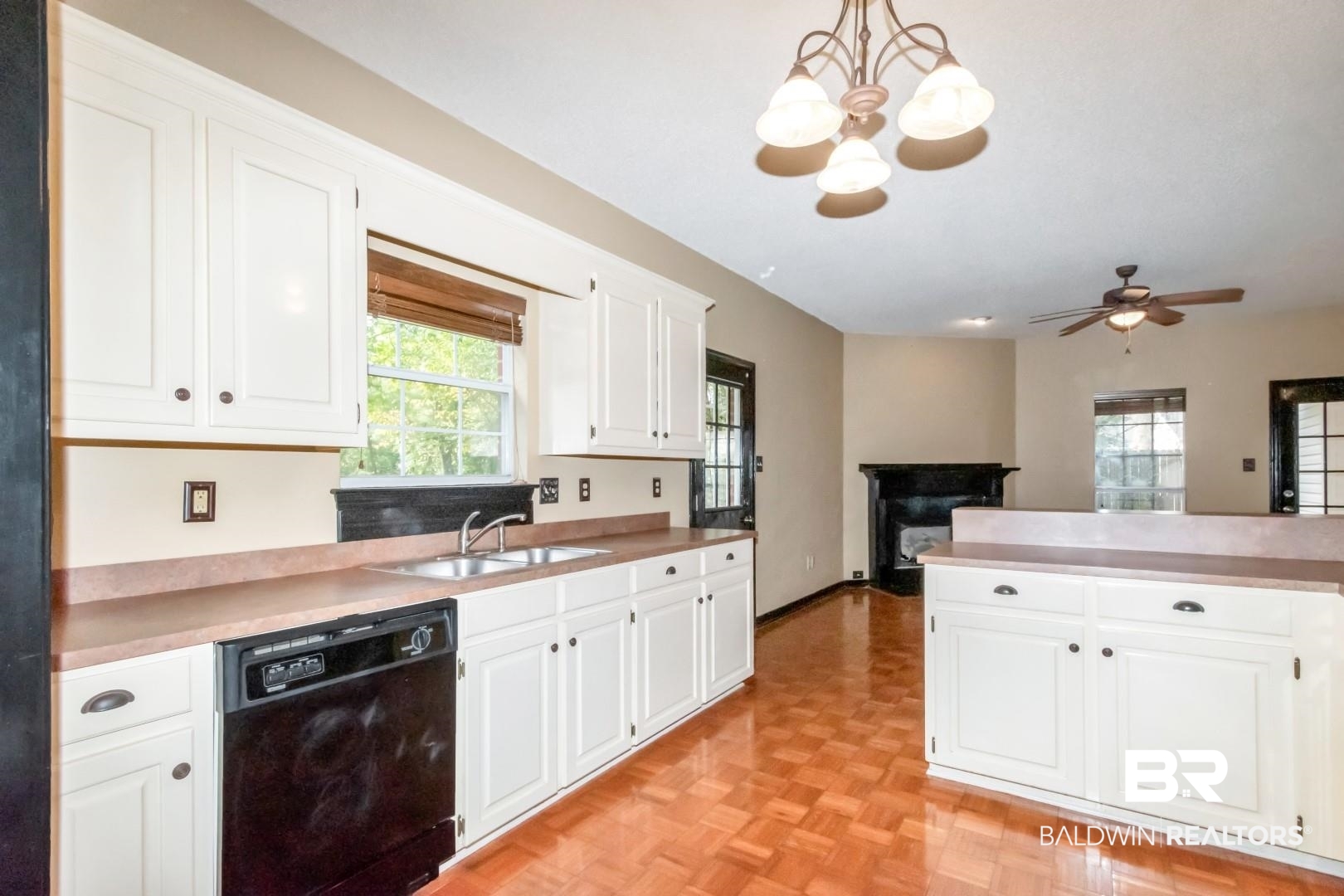 152 Ideal Avenue Mobile, AL 36608 - Photo 12 of 32 Kitchen featuring white cabinets, a healthy amount of sunlight, black dishwasher, and hanging light fixtures
