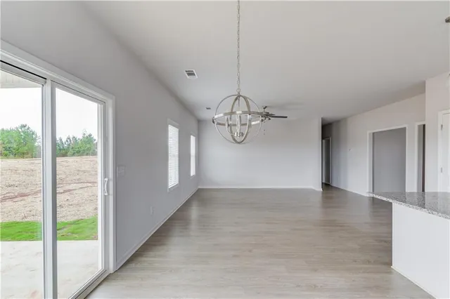 a view of a livingroom with wooden floor and a window