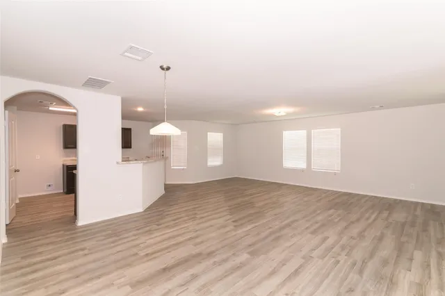 a view of a room with wooden floor and window