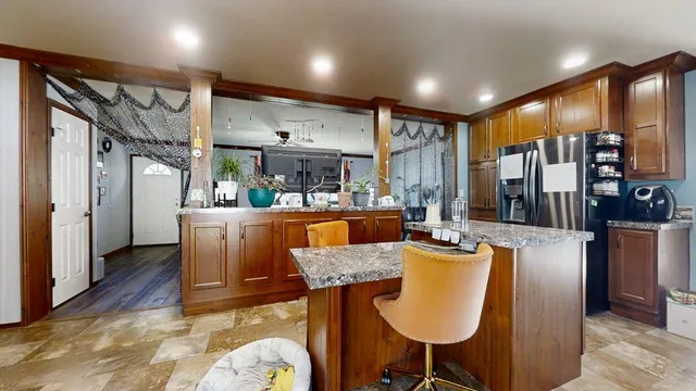 a dining room with furniture a large window and red carpet