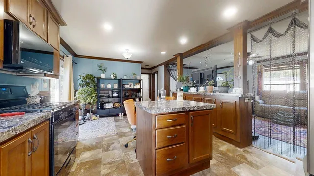 a kitchen with stainless steel appliances granite countertop a sink stove and cabinets