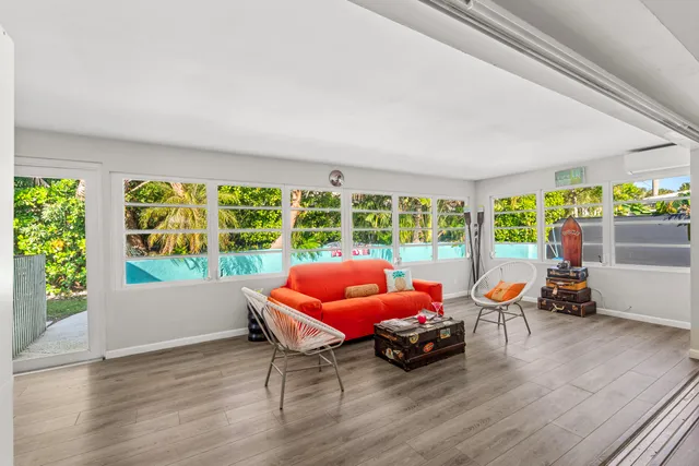 a view of living room and kitchen with furniture and wooden floor