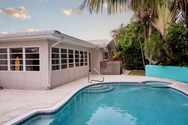 a backyard of a house with table and chairs