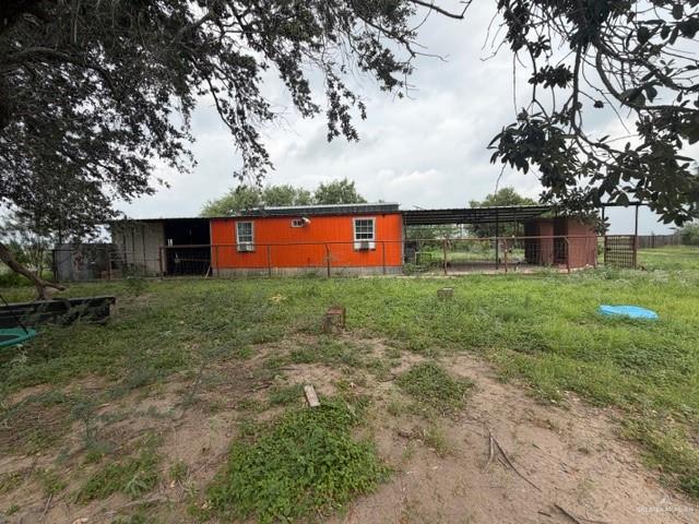 0 Fm 1015 Edcouch, TX 78538 - Photo 15 of 20 Orange-painted structure with multiple windows, an attached covered area, and a fenced enclosure