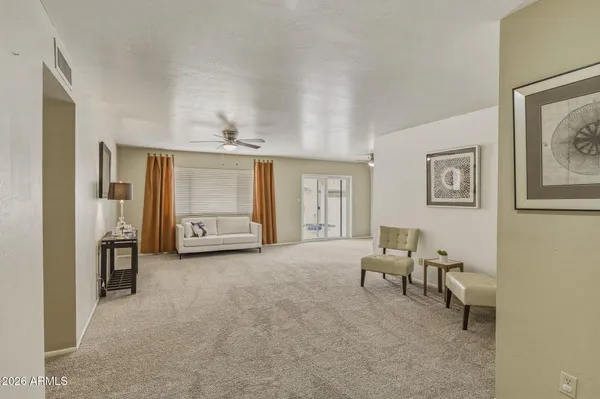 a spacious bedroom with a bed and large mirror