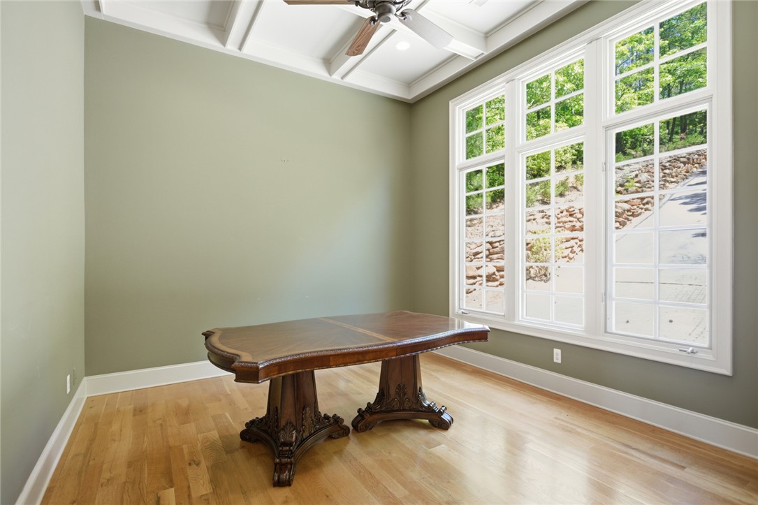 130 River Ridge Road Sunset, SC 29685 - Photo 13 of 47 This naturally illuminated room features a distinct tray ceiling and rich hardwood flooring, offering a versatile space.