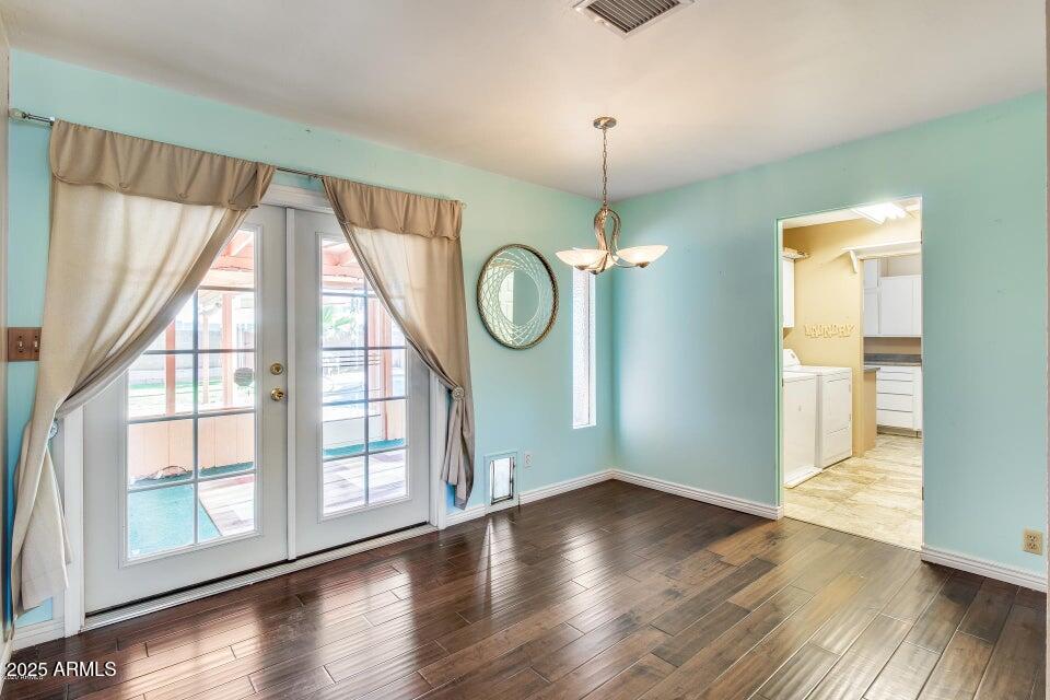 3527 West Yucca Street Phoenix, AZ 85029 - Photo 11 of 20 a view of an empty room with wooden floor and a window
