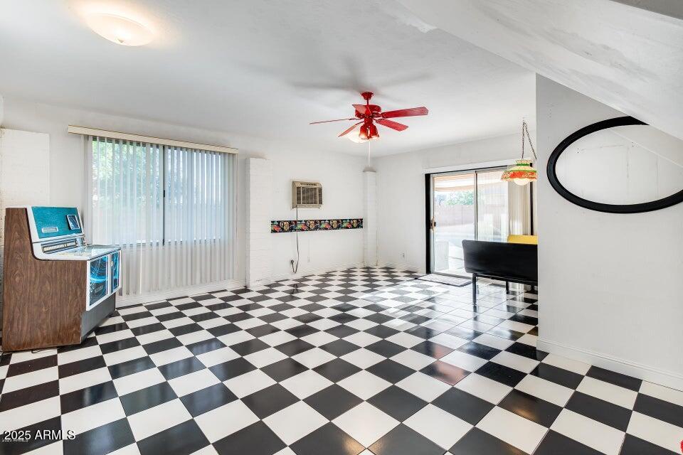 3527 West Yucca Street Phoenix, AZ 85029 - Photo 13 of 20 a living room with a black white checkered floor with a gaming machine and dining table