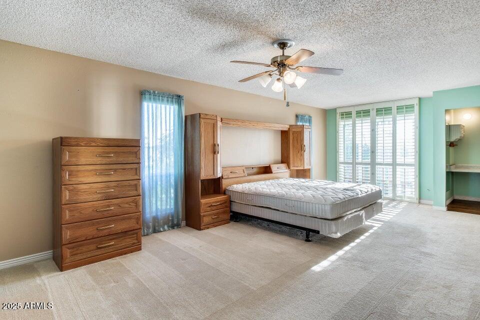 3527 West Yucca Street Phoenix, AZ 85029 - Photo 15 of 20 a bedroom with a bed and a chandelier