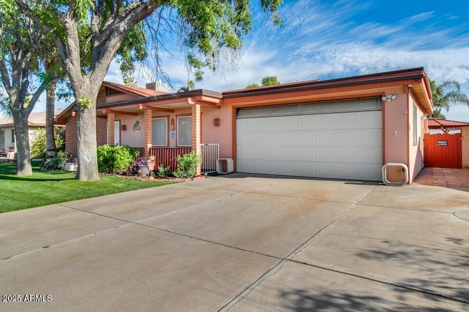 3527 West Yucca Street Phoenix, AZ 85029 - Photo 3 of 20 a front view of a house with a yard and garage