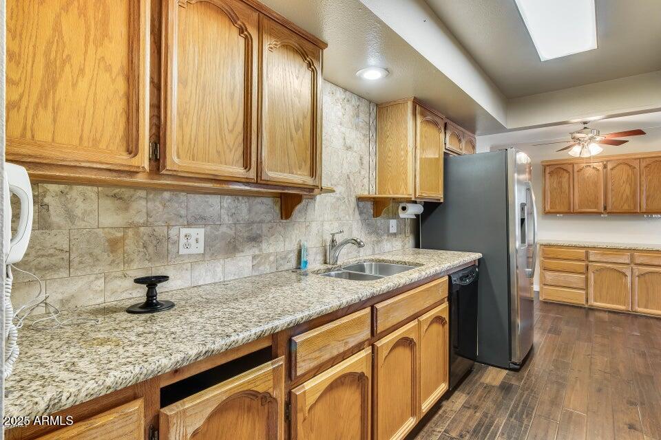 3527 West Yucca Street Phoenix, AZ 85029 - Photo 9 of 20 a kitchen with stainless steel appliances granite countertop a sink a stove cabinets and wooden floor
