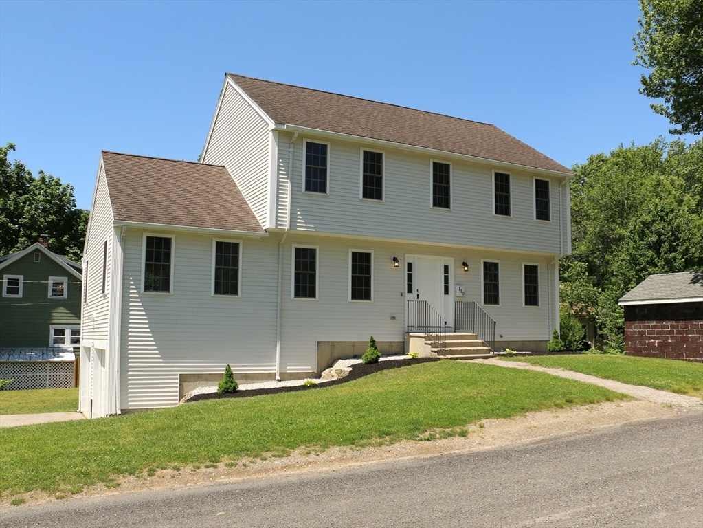 a front view of house with yard and green space