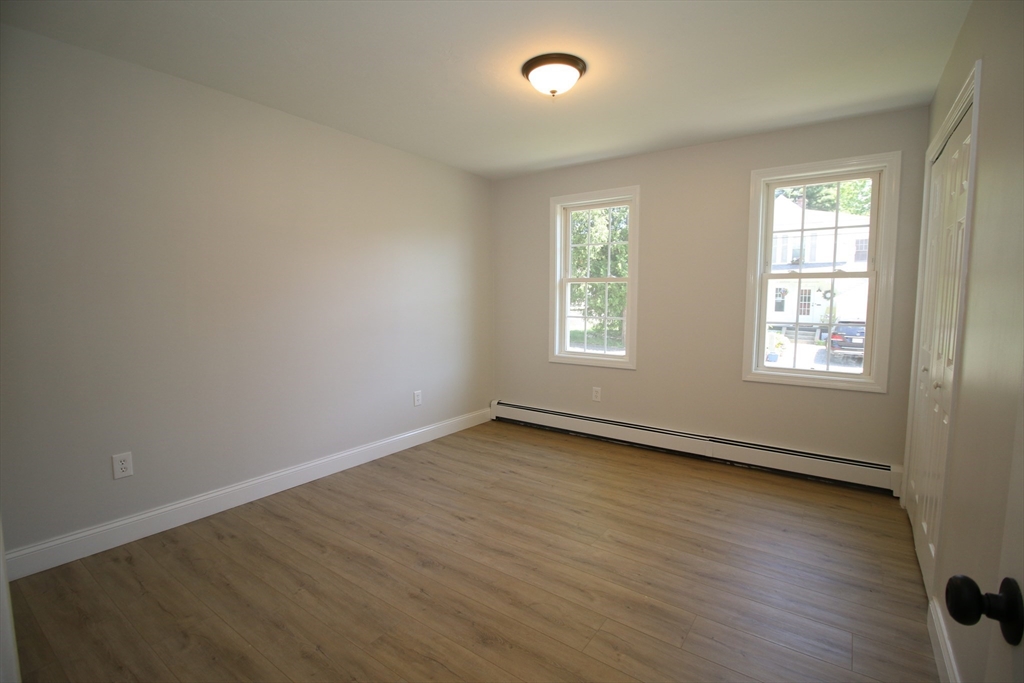 110 St Louis Street Worcester, MA 01607 - Photo 11 of 34 an empty room with wooden floor and windows
