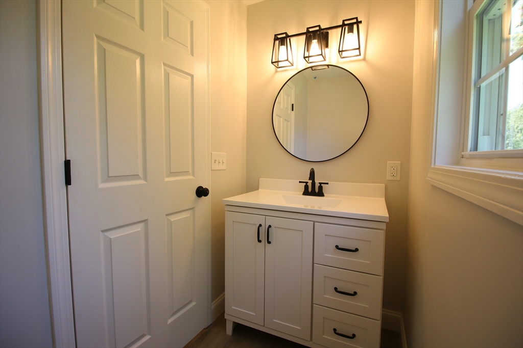 110 St Louis Street Worcester, MA 01607 - Photo 14 of 34 a bathroom with a granite countertop sink and a mirror