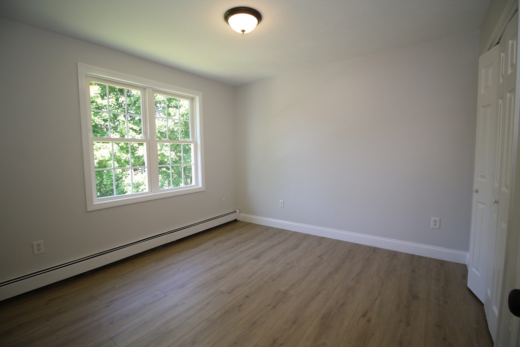 110 St Louis Street Worcester, MA 01607 - Photo 15 of 34 an empty room with wooden floor and windows