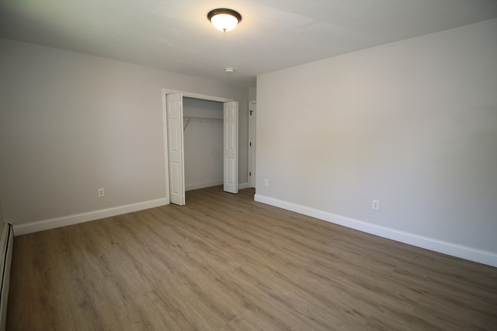 110 St Louis Street Worcester, MA 01607 - Photo 18 of 34 a view of an empty room with wooden floor