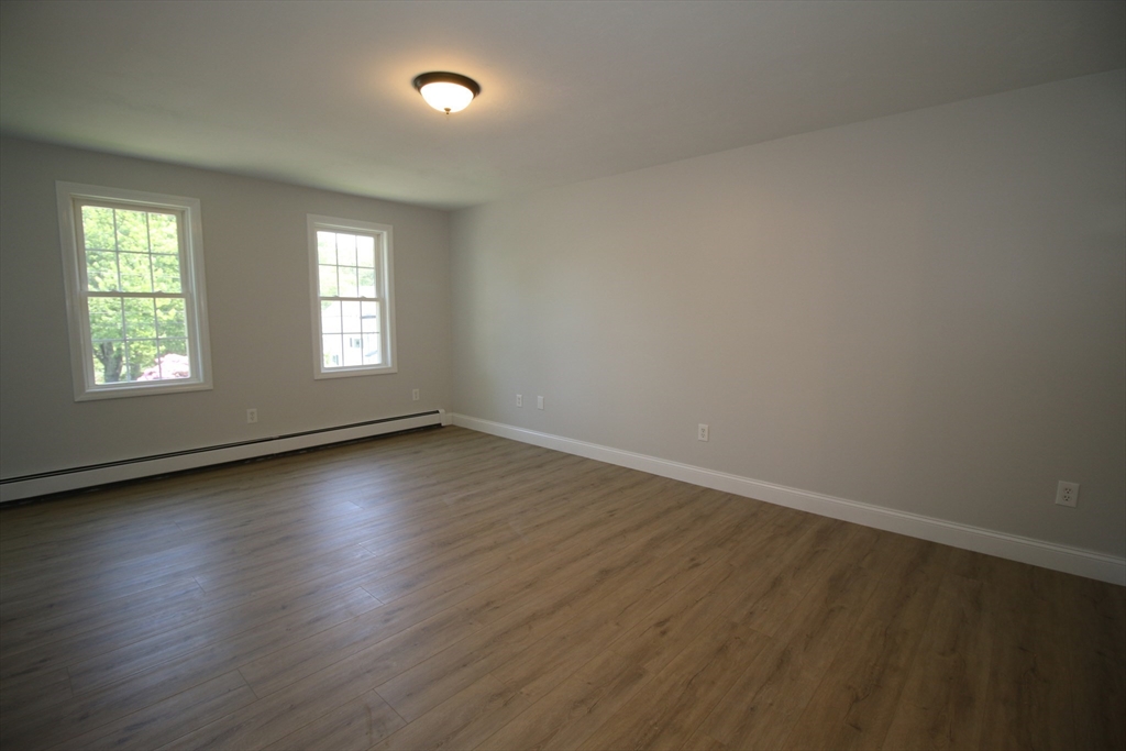 110 St Louis Street Worcester, MA 01607 - Photo 21 of 34 an empty room with wooden floor and windows