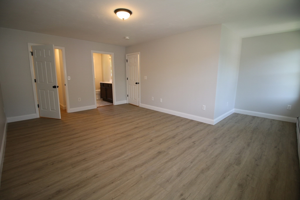 110 St Louis Street Worcester, MA 01607 - Photo 22 of 34 a view of an empty room with wooden floor