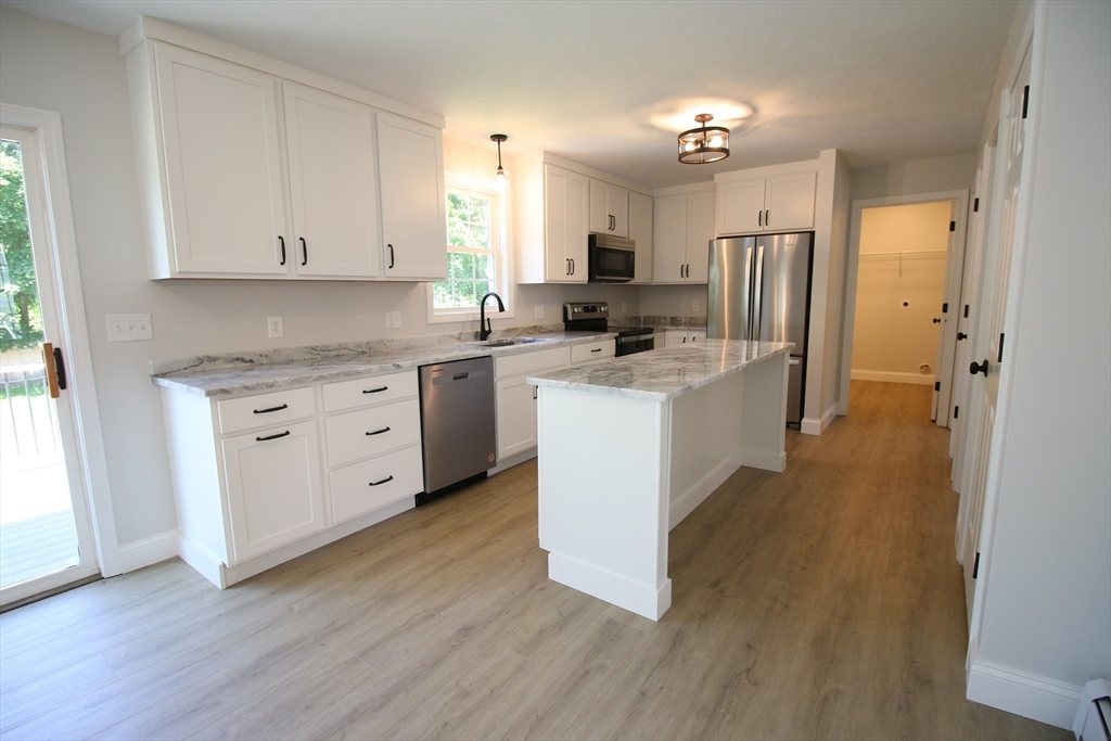 110 St Louis Street Worcester, MA 01607 - Photo 3 of 34 a kitchen with stainless steel appliances a sink cabinets and wooden floor