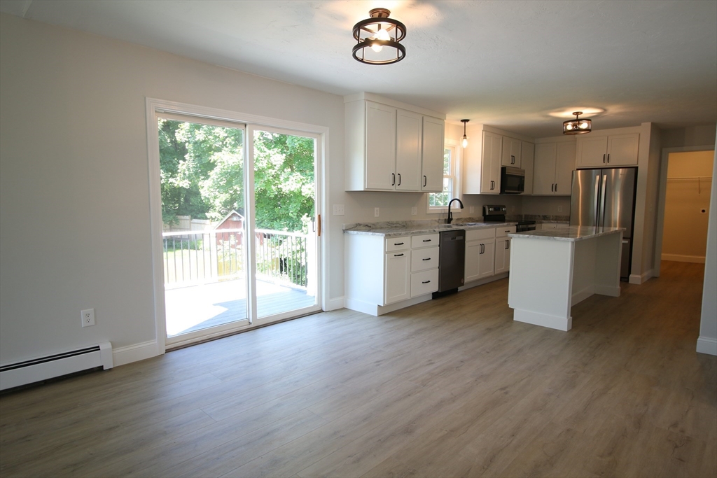 110 St Louis Street Worcester, MA 01607 - Photo 5 of 34 a kitchen with a stove a sink and a refrigerator