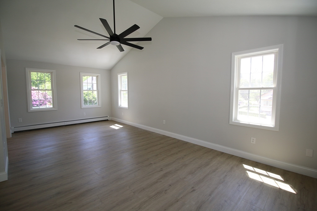 110 St Louis Street Worcester, MA 01607 - Photo 6 of 34 a view of a livingroom with a hardwood floor a ceiling fan and windows