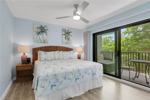 a bedroom with a large bed and a large window