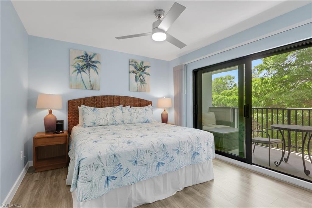 600 Neapolitan Way, Unit 357 Naples, FL 34103 - Photo 11 of 25 a bedroom with a large bed and a large window