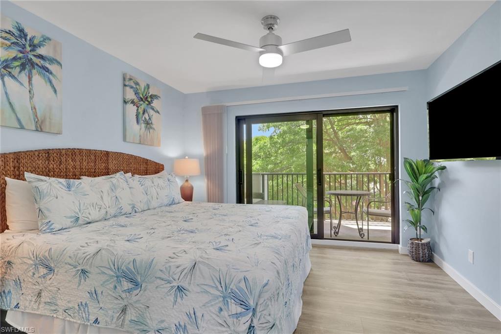 600 Neapolitan Way, Unit 357 Naples, FL 34103 - Photo 12 of 25 a large bedroom with a bed and a flat tv screen on dresser