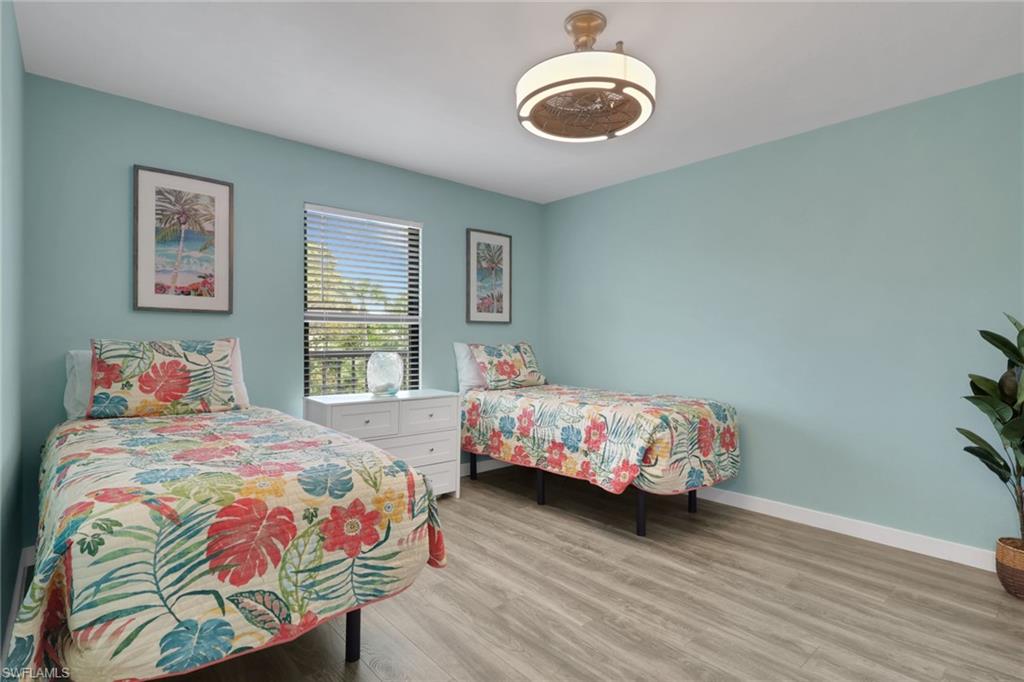 600 Neapolitan Way, Unit 357 Naples, FL 34103 - Photo 18 of 25 a bedroom with a bed and a window