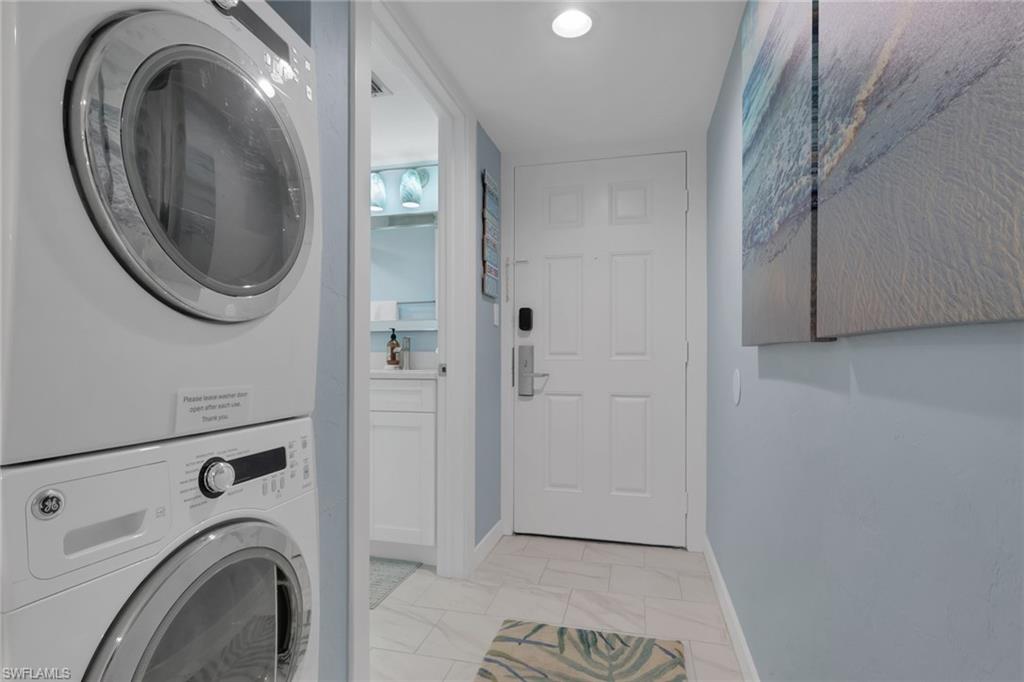 600 Neapolitan Way, Unit 357 Naples, FL 34103 - Photo 20 of 25 a view of a hallway with washer and dryer