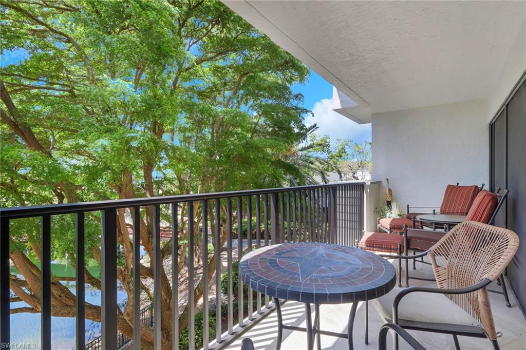 600 Neapolitan Way, Unit 357 Naples, FL 34103 - Photo 22 of 25 a view of balcony with a table and chairs